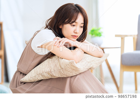 Woman relaxing in the living room Woman relaxing in the living room 98657198