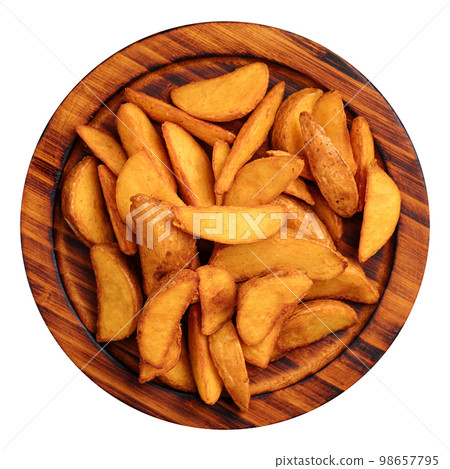 Portion of baked potato wedges on wooden plate Portion of baked potato wedges on wooden plate 98657795