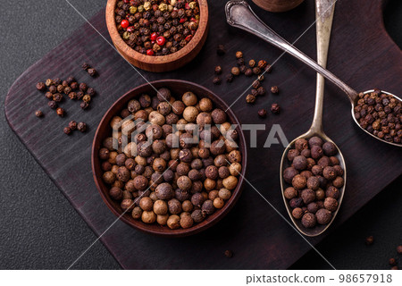 Spice allspice brown color not ground in a wooden saucer. Asian food Spice allspice brown color not ground in a wooden saucer. Asian food 98657918