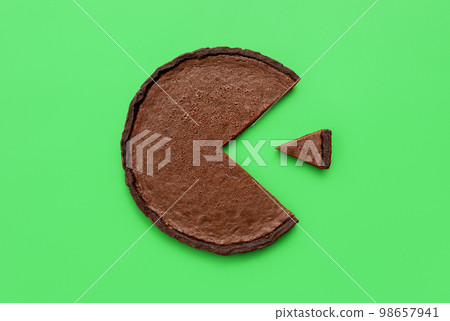 Chocolate tart top view on a green background. Pie chart concept Chocolate tart top view on a green background. Pie chart concept 98657941