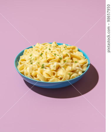 Pasta alfredo dish isolated on a purple background Pasta alfredo dish isolated on a purple background 98657950