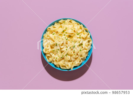 Pasta fettuccine alfredo above view on a purple background Pasta fettuccine alfredo above view on a purple background 98657953