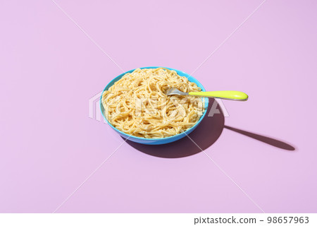 Spaghetti cacio e pepe bowl, isolated on a purple background 98657963