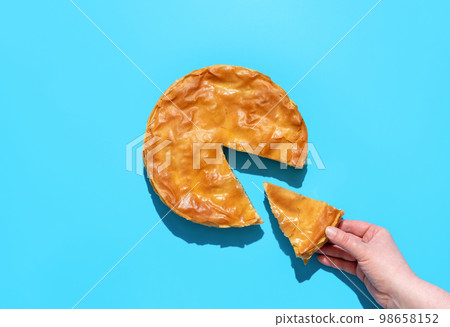 Savory pie with spinach and feta cheese, above view. Balkan phyllo cake Savory pie with spinach and feta cheese, above view. Balkan phyllo cake 98658152
