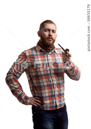 Portrait of handsome bearded redhead man in checked shirt who smoking pipe on white background  98658176
