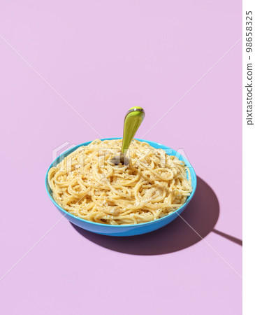 Cheese spaghetti bowl isolated on a purple background Cheese spaghetti bowl isolated on a purple background 98658325