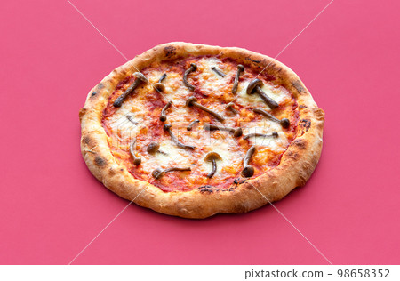 Vegetarian pizza with wild edible mushrooms on a red background Vegetarian pizza with wild edible mushrooms on a red background 98658352