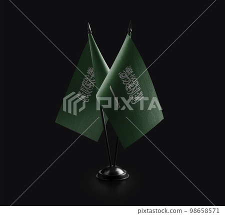 Small national flags of the Saudi Arabia on a black background Small national flags of the Saudi Arabia on a black background 98658571