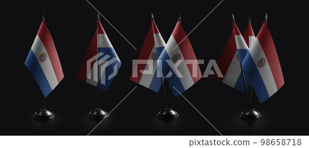 Small national flags of the Paraguay on a black background 98658718
