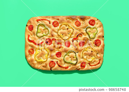 Vegan focaccia above view, minimalist on a green background Vegan focaccia above view, minimalist on a green background 98658748
