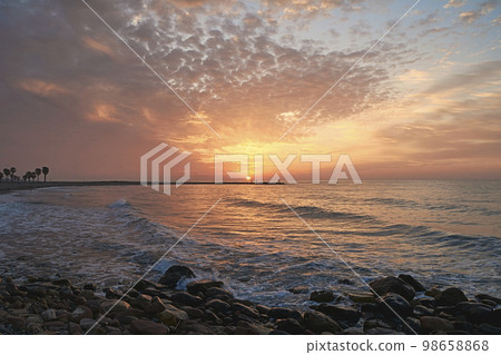 Rocky beach at sunrise, colors 98658868