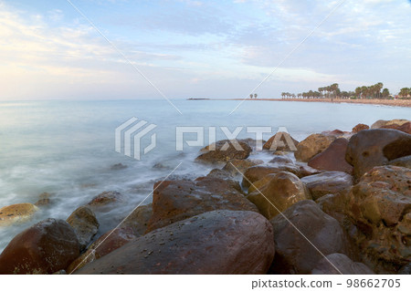 Rocky beach at sunrise, colors 98662705