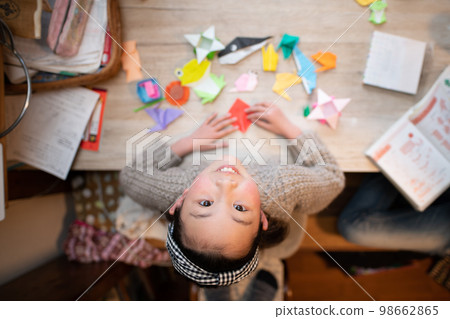 Girl folding Origami Girl folding Origami 98662865