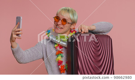 Traveler blogger woman with luggage, taking selfie on smartphone, make online video call, vacation Traveler blogger woman with luggage, taking selfie on smartphone, make online video call, vacation 98662980