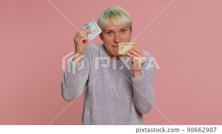 Woman showing plastic credit bank card advertising transferring money, taking loan, online shopping 98662987