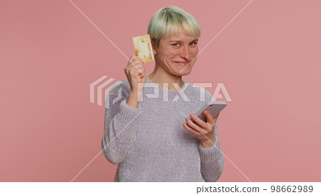 Young woman using credit bank card and smartphone while transferring money purchases online shopping Young woman using credit bank card and smartphone while transferring money purchases online shopping 98662989