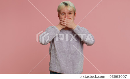 Frightened scared young woman closing her mouth gestures no, refusing to tell terrible secret, truth 98663007