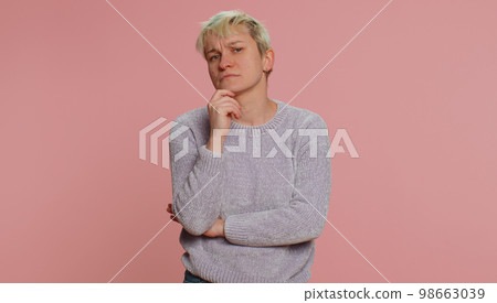 Thoughtful clever woman pondering a solution, doubting question, rubbing chin, pensive expression 98663039
