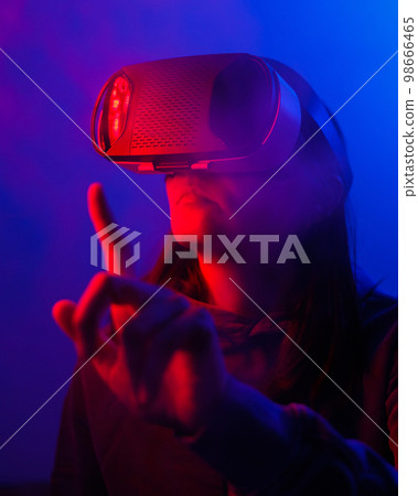 person wearing virtual reality glasses gets experience of gaming and entertainment 98666465