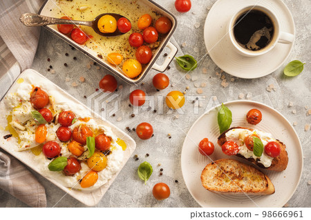 Lunch idea - burrata cheese with baked tomatoes and toasts.   98666961