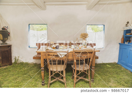 Table with tea and sweets in an old Ukrainian hut 98667017