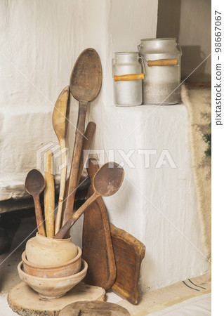 Wooden and ceramic dishes in an old Ukrainian hut Wooden and ceramic dishes in an old Ukrainian hut 98667067