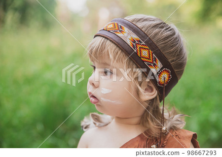 Cute baby dressed in traditional Native American costume Cute baby dressed in traditional Native American costume 98667293