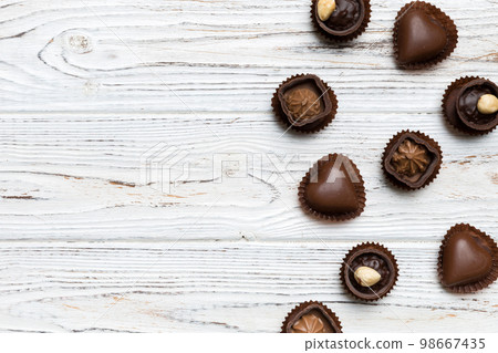 Different kinds of chocolates on colored table close-up. Top View and Flat Lay with copy space Different kinds of chocolates on colored table close-up. Top View and Flat Lay with copy space 98667435