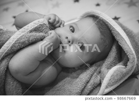 beautiful newborn baby wrapped in a towel after bathing beautiful newborn baby wrapped in a towel after bathing 98667669