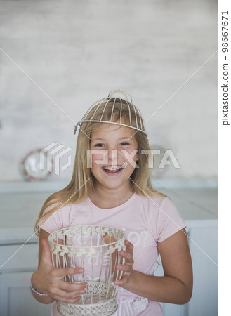 teen girl standing with a basket on her head in the kitchen teen girl standing with a basket on her head in the kitchen 98667671