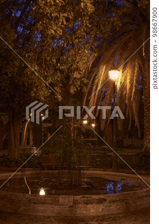 Romantic night park, with fountain and lamppost Romantic night park, with fountain and lamppost 98667900