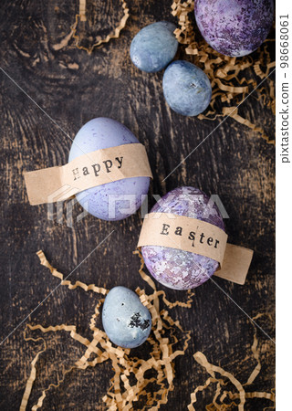 Festive Easter eggs in purple and blue color 98668061