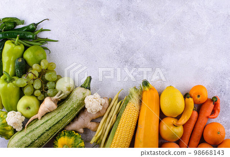Assortment of yellow and red vegetables and fruits 98668143