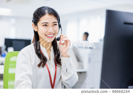 Young woman working in a call center Young woman working in a call center 98668284