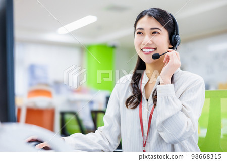 Young woman working in a call center Young woman working in a call center 98668315