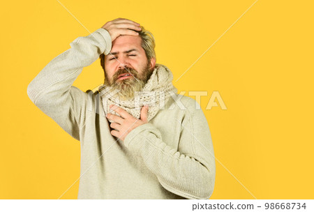 bearded hipster sick. coronavirus from china. prevent virus infection. man with cold feel fever. cough and runny nose first symptoms. brutal male get flu in winter. warm up with knitwear. copy space 98668734