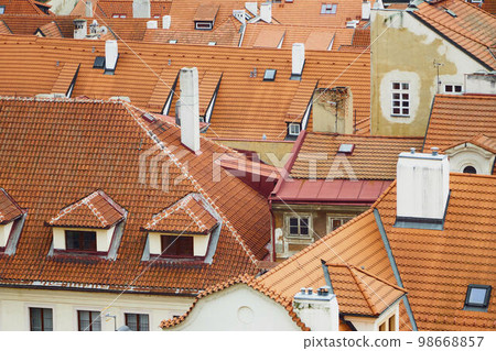Tile traditional orange rooftops of houses in Prague during journey. 98668857