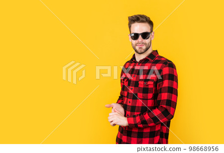 bearded man with bristle on unshaven face. fashion and beauty. barbershop concept. mens wear. young handsome guy in checkered shirt and glasses. stylish male wear casual clothes 98668956