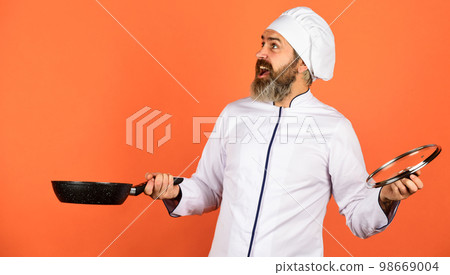 High quality frying pan. Bearded man cook white uniform. Cooking like pro. Regular cooking. Easy tasty meal prepared at home. Homemade breakfast. Preparing food in kitchen. Cooking food concept 98669004