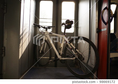 Bicycle standing in the vestibule. Tourism with a bicycle. Transport the bike on the train. Travel with a bike. 98669172