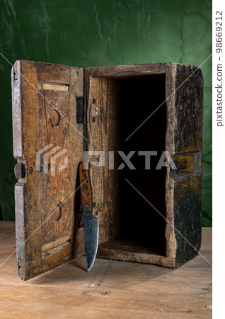 Old wooden box and old knife. Vintage tool. Homemade box and knife. Old wooden box and old knife. Vintage tool. Homemade box and knife. 98669212