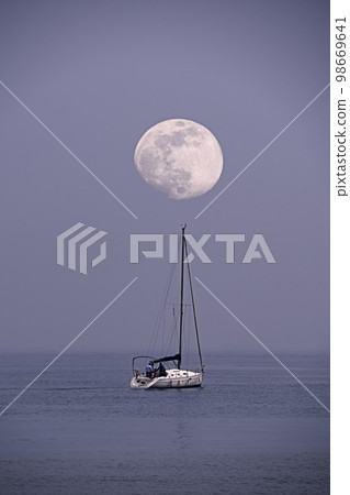 Sailboat sailing on the sea with the moon Sailboat sailing on the sea with the moon 98669641