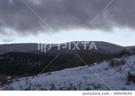 Snowy mountain landscape, cloudy sky 98669648