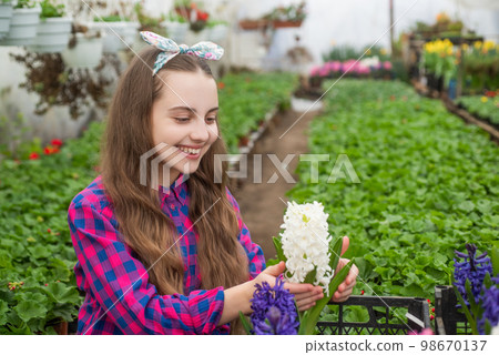 vintage style. spring and summer. planting pot plants. child gardener. flowers in garden. vintage style. spring and summer. planting pot plants. child gardener. flowers in garden. 98670137