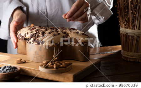 Colomba with chocolate. Easter Italian cake with almonds and chocolate in the shape of a dove.  98670339