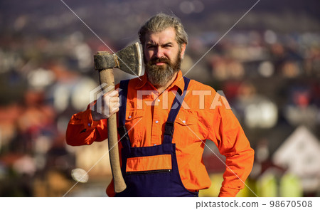 confident in his work. build and construction. Skilled architect repair and fix. engineer career. bearded man in uniform. mature man builder use axe. professional repairman working with ax tool confident in his work. build and construction. Skilled architect repair and fix. engineer career. bearded man in uniform. mature man builder use axe. professional repairman working with ax tool 98670508