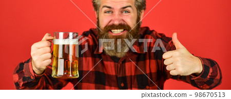 toasting and cheering aperitif. leisure and celebration. Man drinking beer in bar. Beer with foam. brutal hipster drink beer. mature bearded barman hold beer glass. confident bartender raising toast toasting and cheering aperitif. leisure and celebration. Man drinking beer in bar. Beer with foam. brutal hipster drink beer. mature bearded barman hold beer glass. confident bartender raising toast 98670513