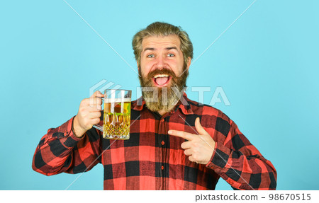 Beer with foam. Hipster drink beer. Mature bearded guy hold beer glass. Holiday celebration. Cheers toast. Bachelor day. Improve mood. Get drunk. Alcoholic. Thirsty man drinking beer in pub bar 98670515