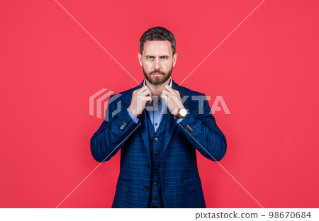 handsome man in formalwear dressing and grooming, fashion 98670684