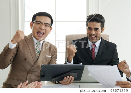 Close up of happy success group of businesspeople during presentation. Colleagues cheering and smiling. Close up of happy success group of businesspeople during presentation. Colleagues cheering and smiling. 98671259